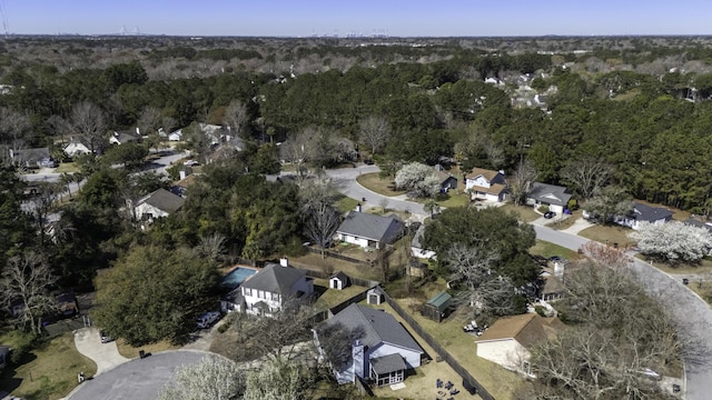 drone / aerial view with a forest view and a residential view