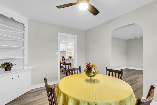 dining area with hardwood / wood-style flooring and ceiling fan