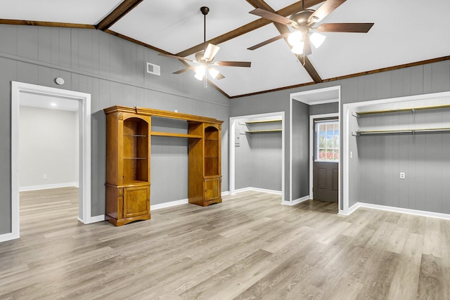 unfurnished bedroom featuring two closets, ceiling fan, light hardwood / wood-style flooring, and lofted ceiling