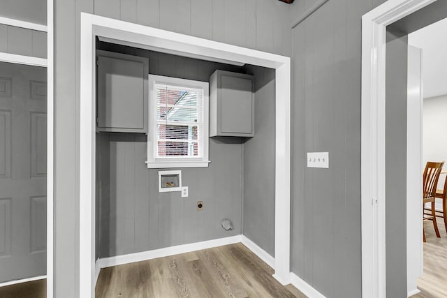 laundry room featuring washer hookup, hookup for an electric dryer, hardwood / wood-style floors, and wooden walls