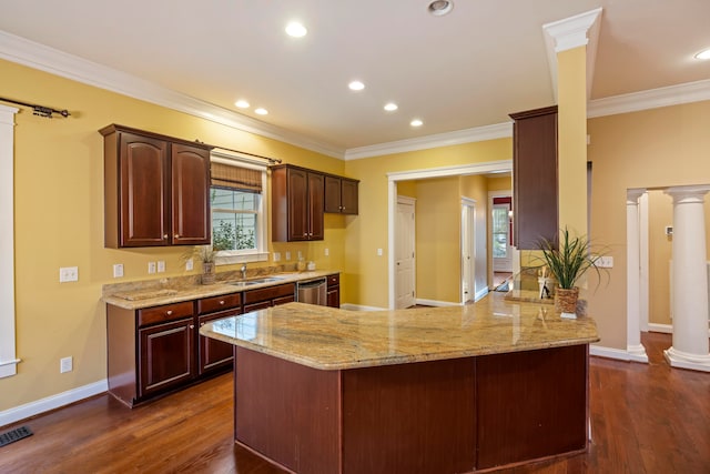 kitchen with dishwasher, kitchen peninsula, dark hardwood / wood-style floors, and decorative columns