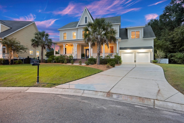 view of front of house featuring a garage, a porch, and a yard