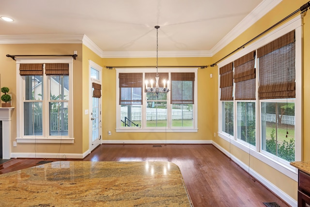 interior space featuring ornamental molding, dark hardwood / wood-style floors, and a chandelier