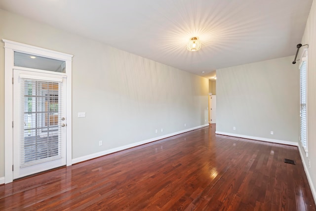 spare room with dark hardwood / wood-style floors