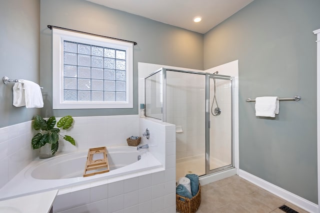 bathroom with independent shower and bath and tile patterned floors