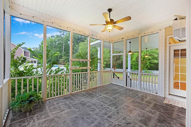 unfurnished sunroom featuring ceiling fan and wooden ceiling