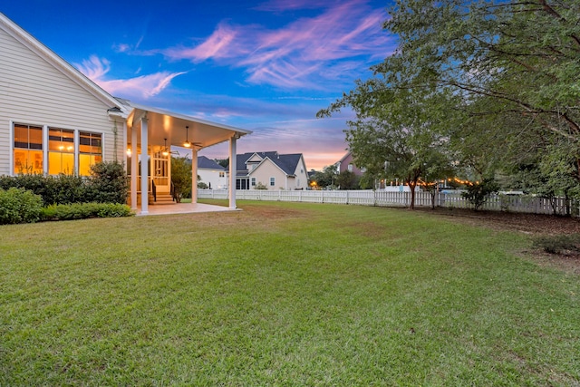 view of yard at dusk