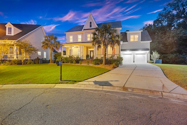 view of front of property with a garage, covered porch, and a lawn