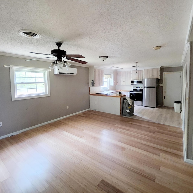 1201 Crescent St, Summerton, SC 29148 - unfurnished living room featuring light wood-type flooring, a textured ceiling, and a ceiling fan