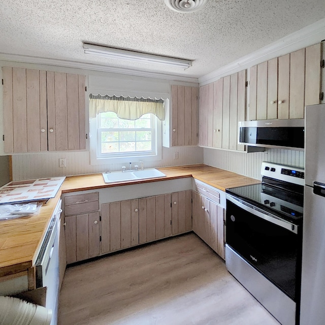 1201 Crescent St, Summerton, SC 29148 - kitchen with stainless steel appliances, light wood-type flooring, ventilation hood, a textured ceiling, and butcher block counters