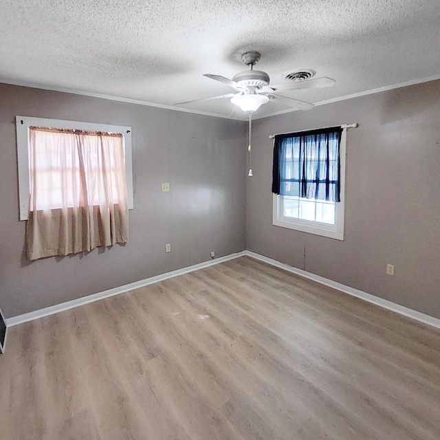 1201 Crescent St, Summerton, SC 29148 - spare room with a textured ceiling, wood finished floors, ceiling fan, and crown molding