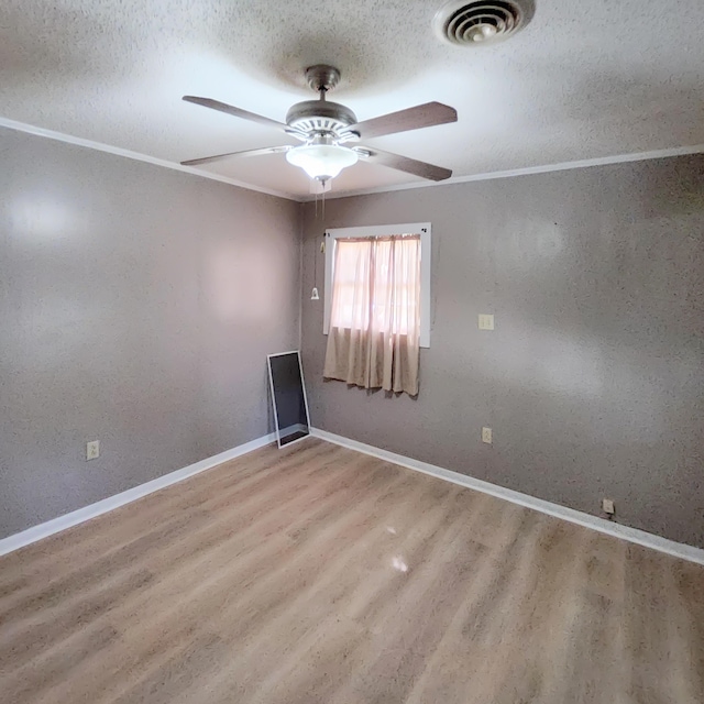 1201 Crescent St, Summerton, SC 29148 - empty room featuring a textured ceiling, a ceiling fan, wood finished floors, and ornamental molding