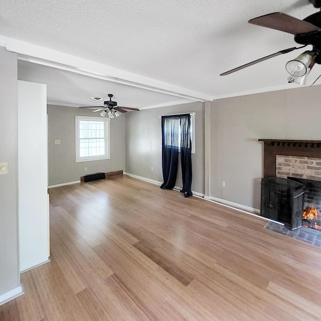 1201 Crescent St, Summerton, SC 29148 - unfurnished living room with a ceiling fan, a textured ceiling, a brick fireplace, and light wood-type flooring