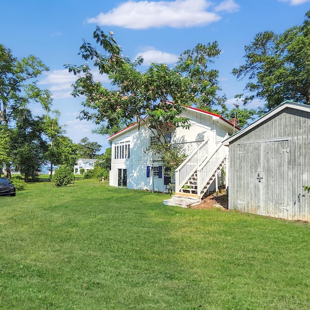1201 Crescent St, Summerton, SC 29148 - rear view of property with a yard, stairs, and a storage shed