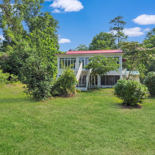 1201 Crescent St, Summerton, SC 29148 - rear view of house featuring stairway, a sunroom, a yard, a metal roof, and a deck