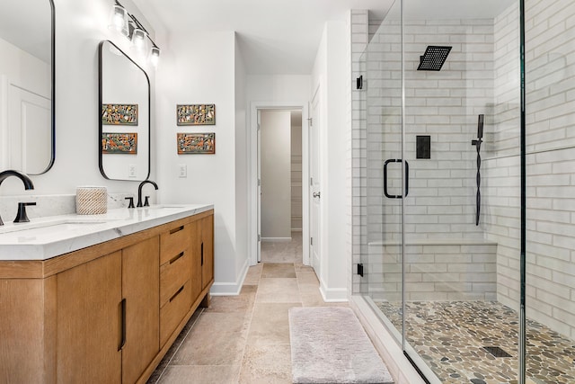 full bathroom with double vanity, a sink, and a shower stall