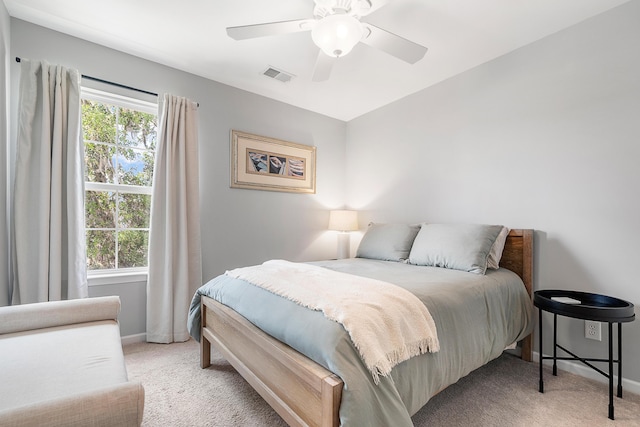 bedroom with visible vents, baseboards, ceiling fan, and light colored carpet