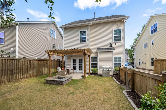 rear view of house featuring french doors, a pergola, a yard, and a patio area