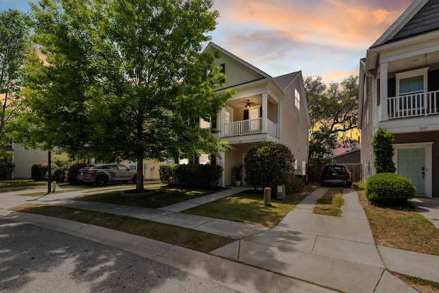 property exterior at dusk featuring a ceiling fan