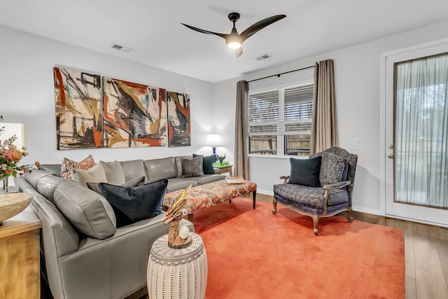 living room featuring hardwood / wood-style floors and ceiling fan