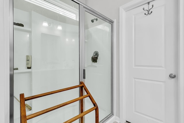 bathroom featuring a shower with door