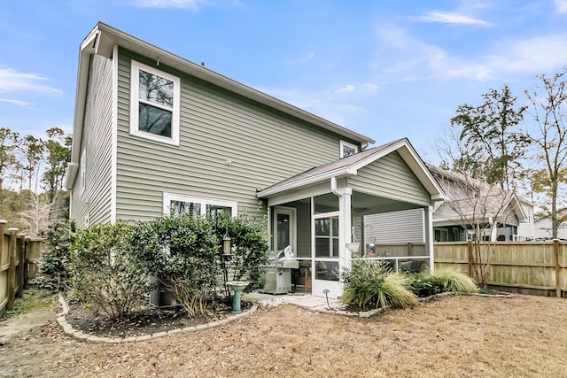 rear view of property with a sunroom