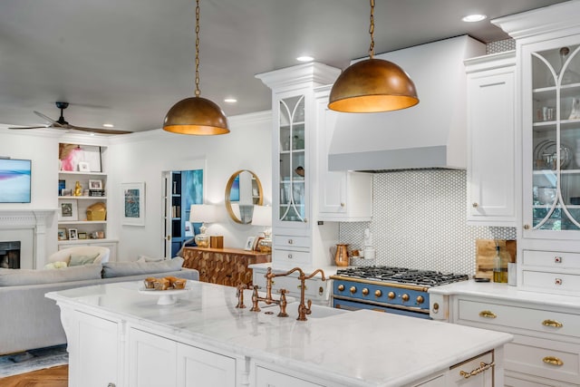 kitchen with white cabinetry, open floor plan, pendant lighting, and ceiling fan