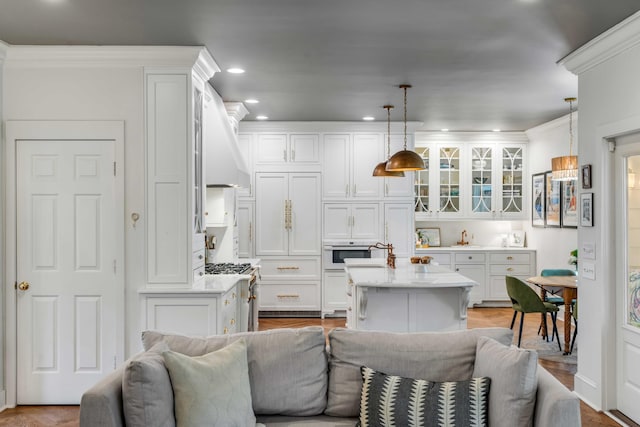 living room featuring recessed lighting and ornamental molding