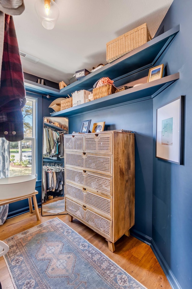spacious closet featuring wood finished floors and visible vents