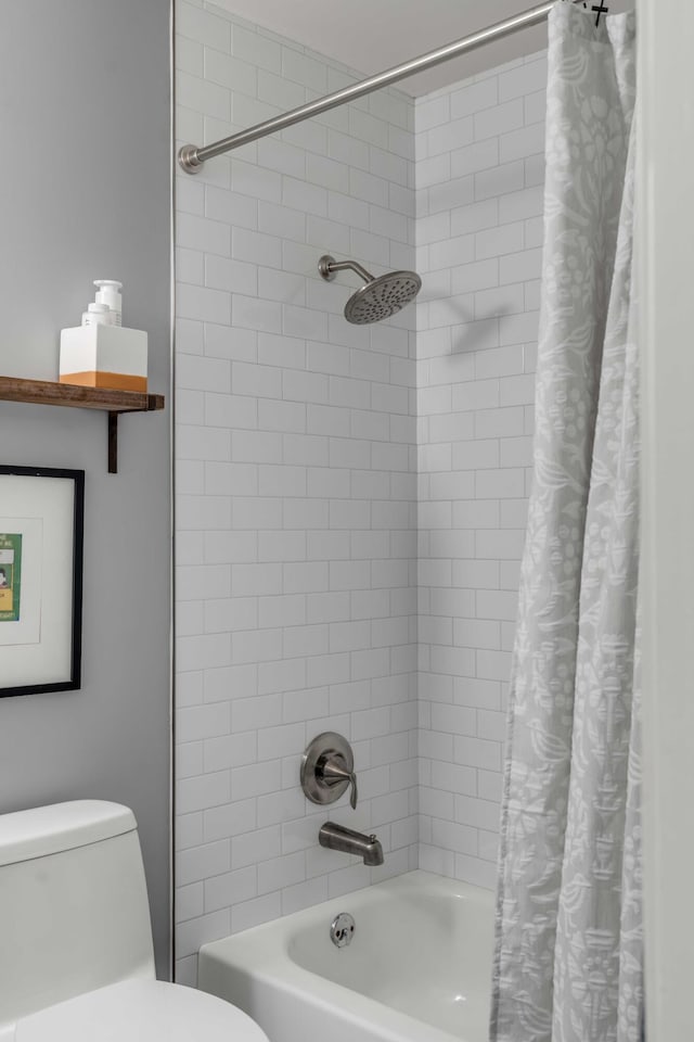 bathroom featuring shower / bath combo with shower curtain and toilet