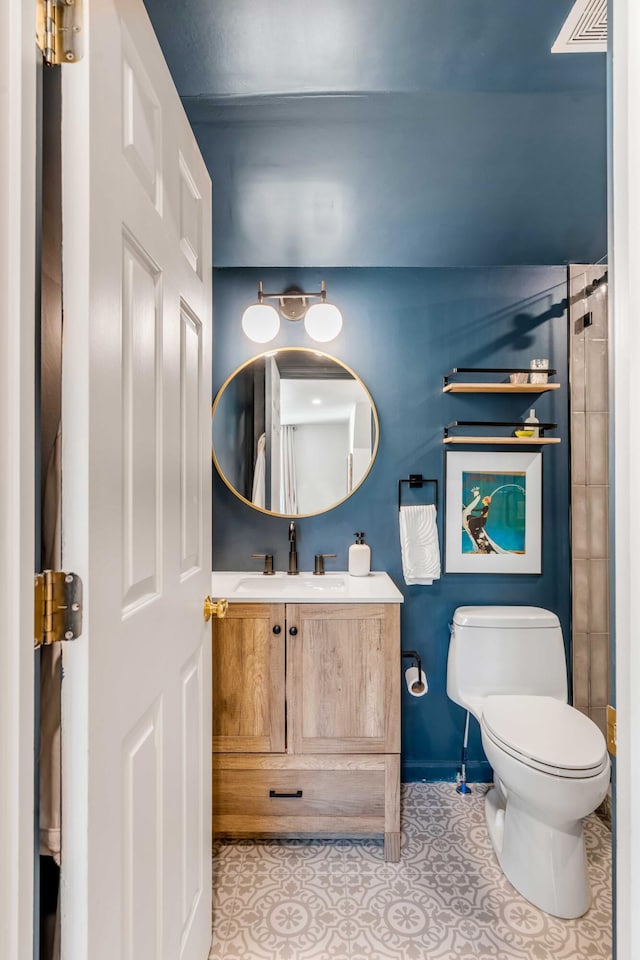 bathroom featuring vanity, tile patterned flooring, toilet, and visible vents