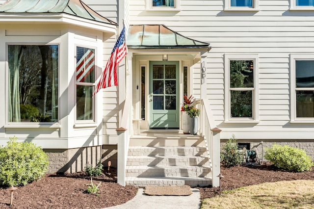 doorway to property featuring a standing seam roof