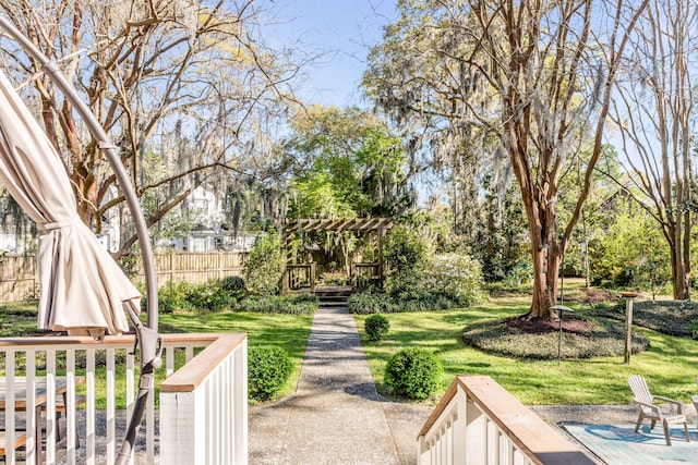 exterior space with fence, a pergola, a yard, and a wooden deck