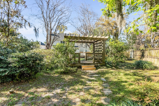 view of yard featuring a pergola, fence, and a deck