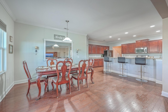 dining area with ornamental molding, recessed lighting, baseboards, and hardwood / wood-style floors