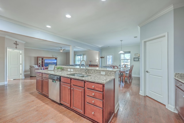 kitchen with crown molding, light wood finished floors, open floor plan, a sink, and dishwasher