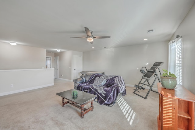 living area with carpet floors, visible vents, baseboards, and ceiling fan