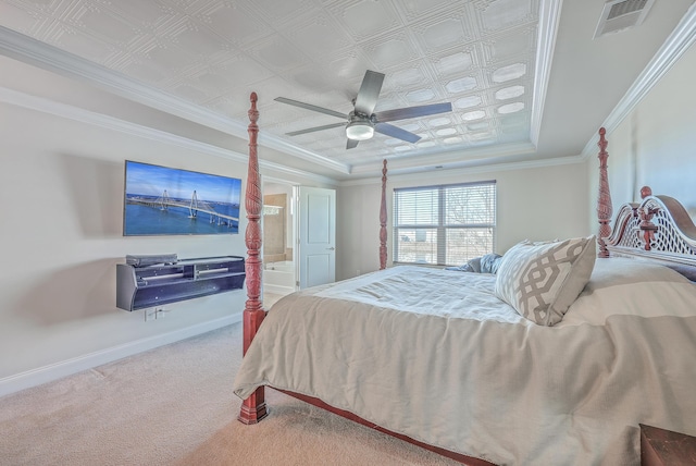 carpeted bedroom with baseboards, visible vents, ceiling fan, ornamental molding, and a tray ceiling