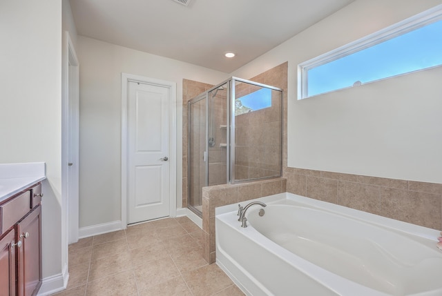 full bathroom with baseboards, tile patterned flooring, vanity, a shower stall, and a bath