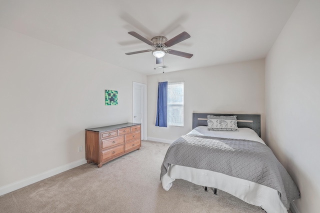 bedroom with baseboards, ceiling fan, and light colored carpet