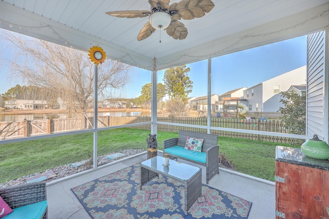 sunroom with a residential view and a ceiling fan