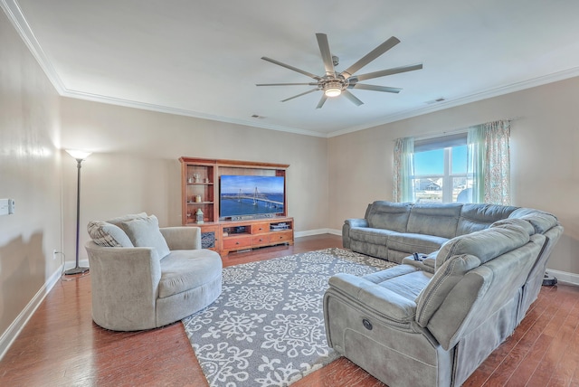 living area with ornamental molding, baseboards, and wood finished floors