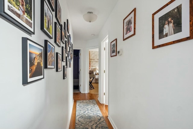 hall with wood finished floors and baseboards