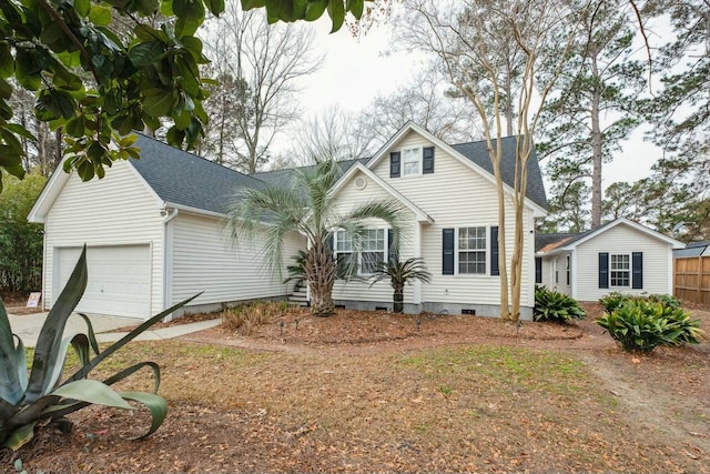 view of front of property featuring driveway, a shingled roof, crawl space, and an attached garage