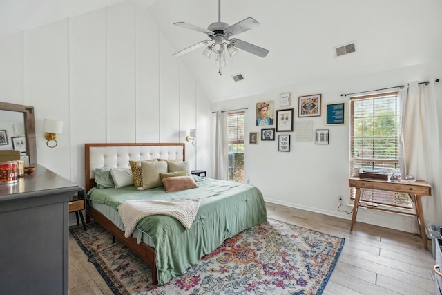 bedroom featuring visible vents, high vaulted ceiling, light wood-style flooring, and a ceiling fan