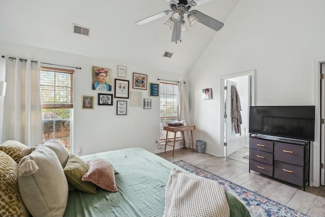 bedroom with visible vents, multiple windows, and light wood-style floors