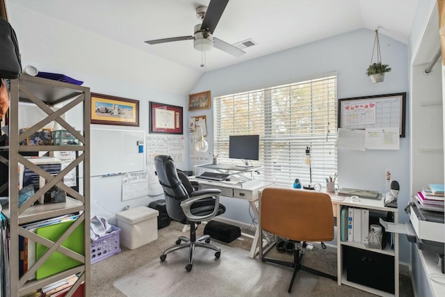 carpeted office space featuring visible vents, ceiling fan, and lofted ceiling