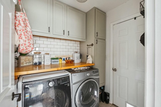 clothes washing area with cabinet space and separate washer and dryer