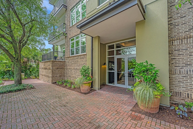 145 Pier View St Unit 214, Daniel Island, SC 29492 - doorway to property with french doors, brick siding, and stucco siding