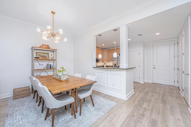 145 Pier View St Unit 214, Daniel Island, SC 29492 - dining room with light wood-style flooring, a chandelier, ornamental molding, baseboards, and recessed lighting